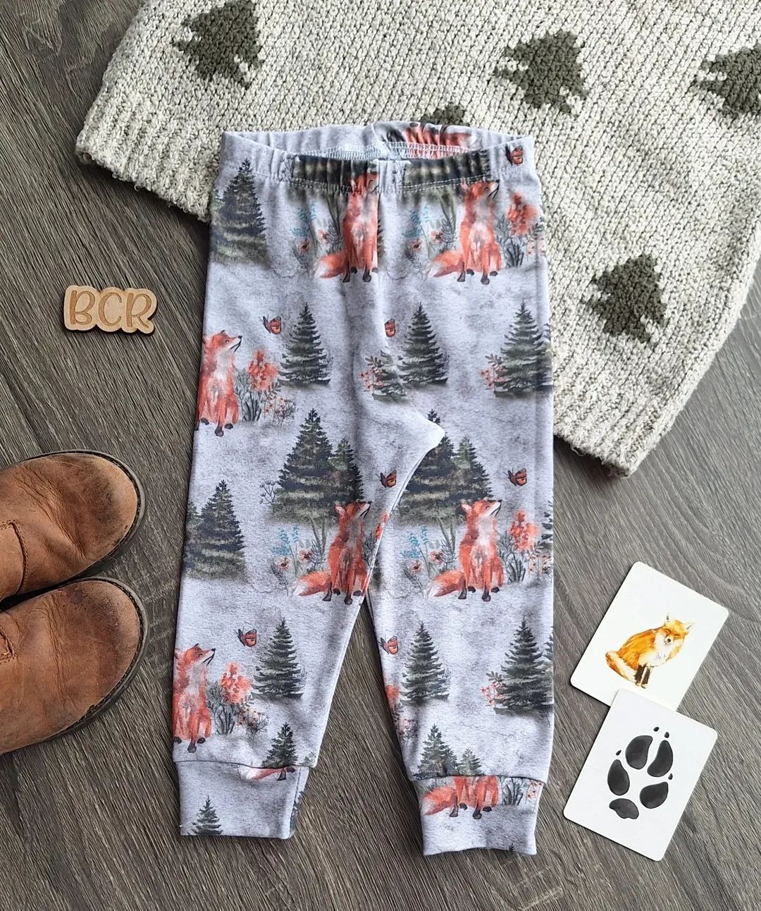 flat lay of organic cotton baby leggings with fox trees and butterflies