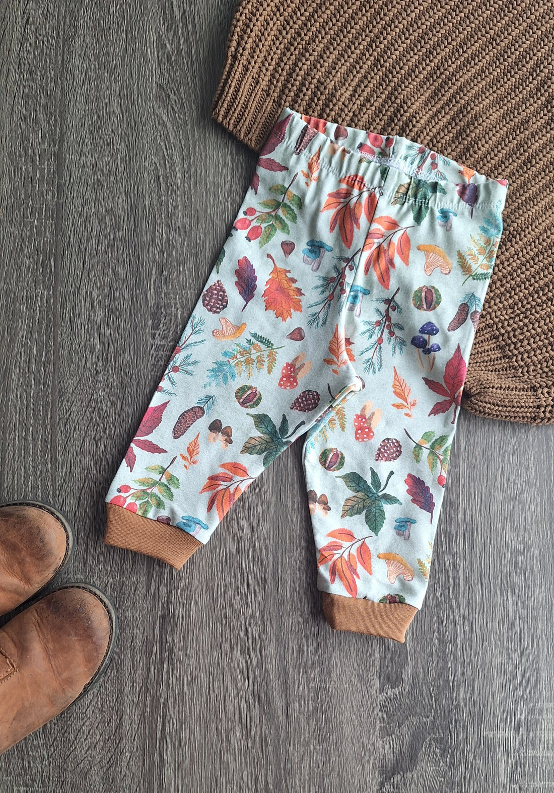 Newborn Leggings with autumn ,eaves fabric featuring a sage background.